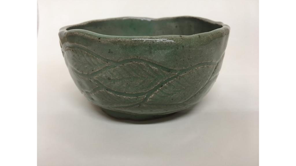 Green clay bowl with leaf etching around side