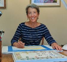 Photo of instructor Beth Owen mid watercolor session with a big smile on her face.