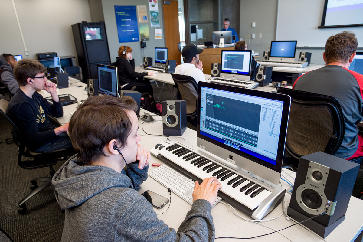 A Digital music class with students using keyboards and computers